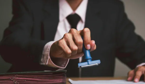 Serene Budigere Approvals — RERA Under Process Document being officially stamped, representing RERA registration and statutory approval processes for Serene Budigere
